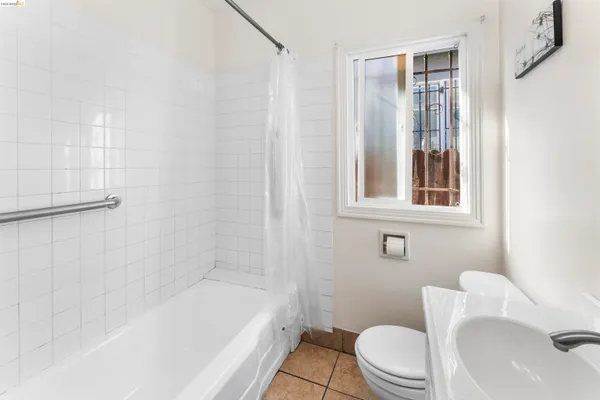 a bathroom with a toilet and a bathtub