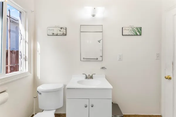 a bathroom with a sink a toilet and a mirror