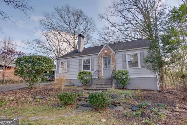 a front view of house with yard and green space