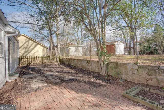 a view of a yard with large trees