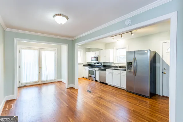 a kitchen with stainless steel appliances a refrigerator a stove top oven and sink