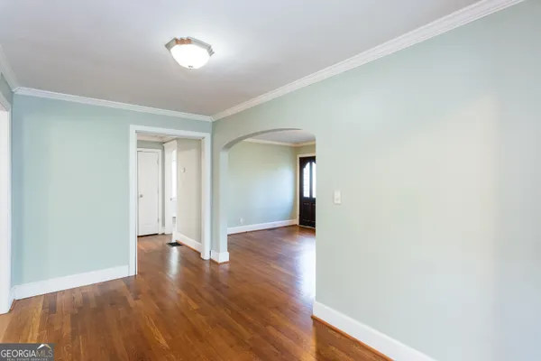 a view of an empty room with wooden floor