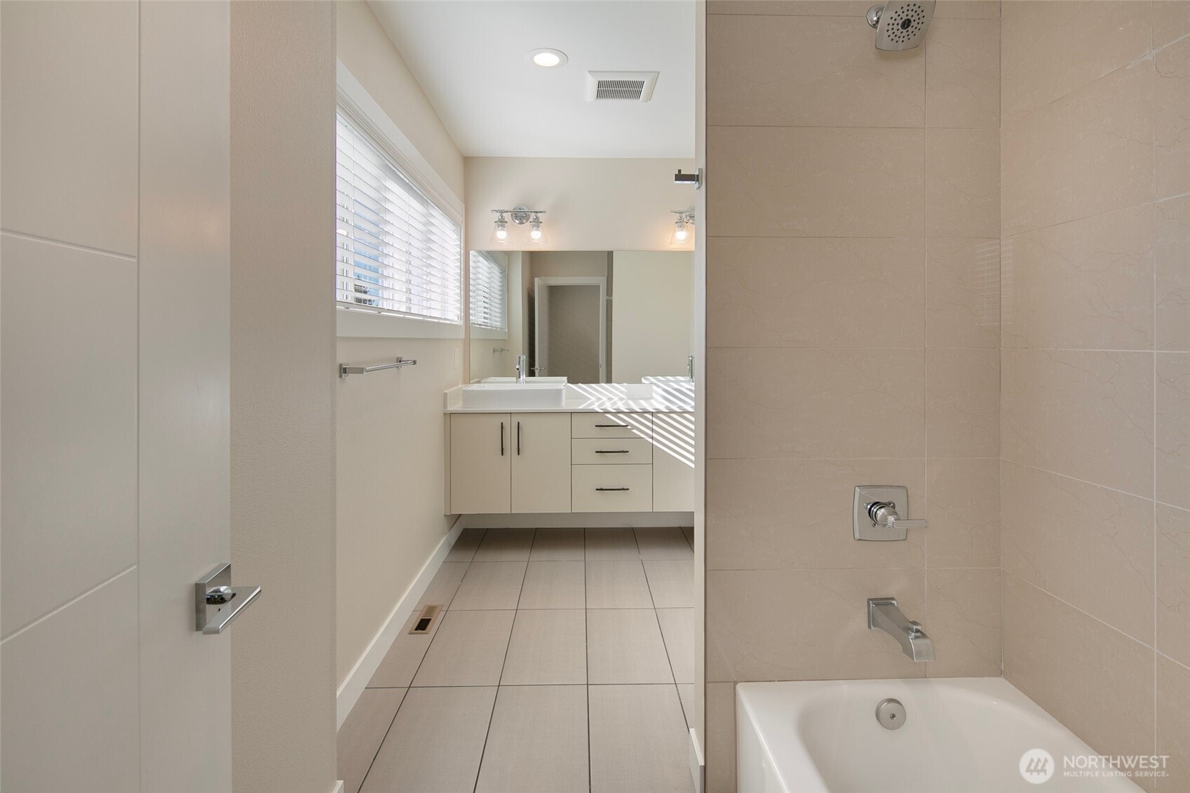 11838 79th Avenue South Seattle, WA 98178 - Photo 12 of 38 a bathroom with a bathtub a sink a toilet and a mirror