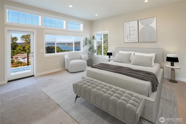 a bedroom with furniture and a large window