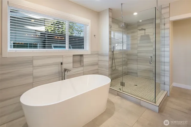 a white bath tub sitting next to a shower