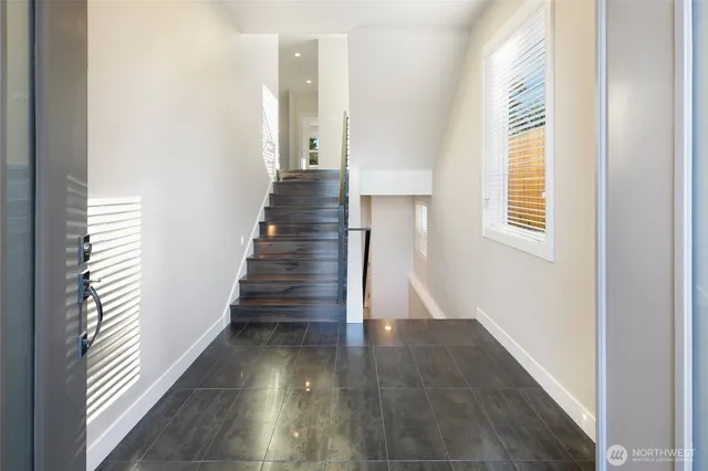 a view of entryway and hall with wooden floor