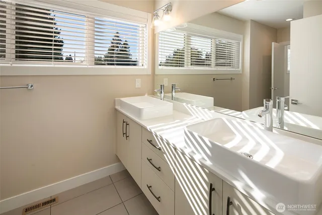 a bathroom with a sink and a window