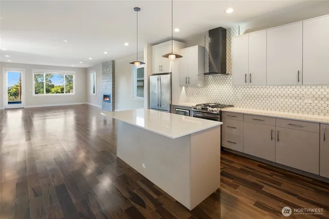 a kitchen with a sink appliances and cabinets