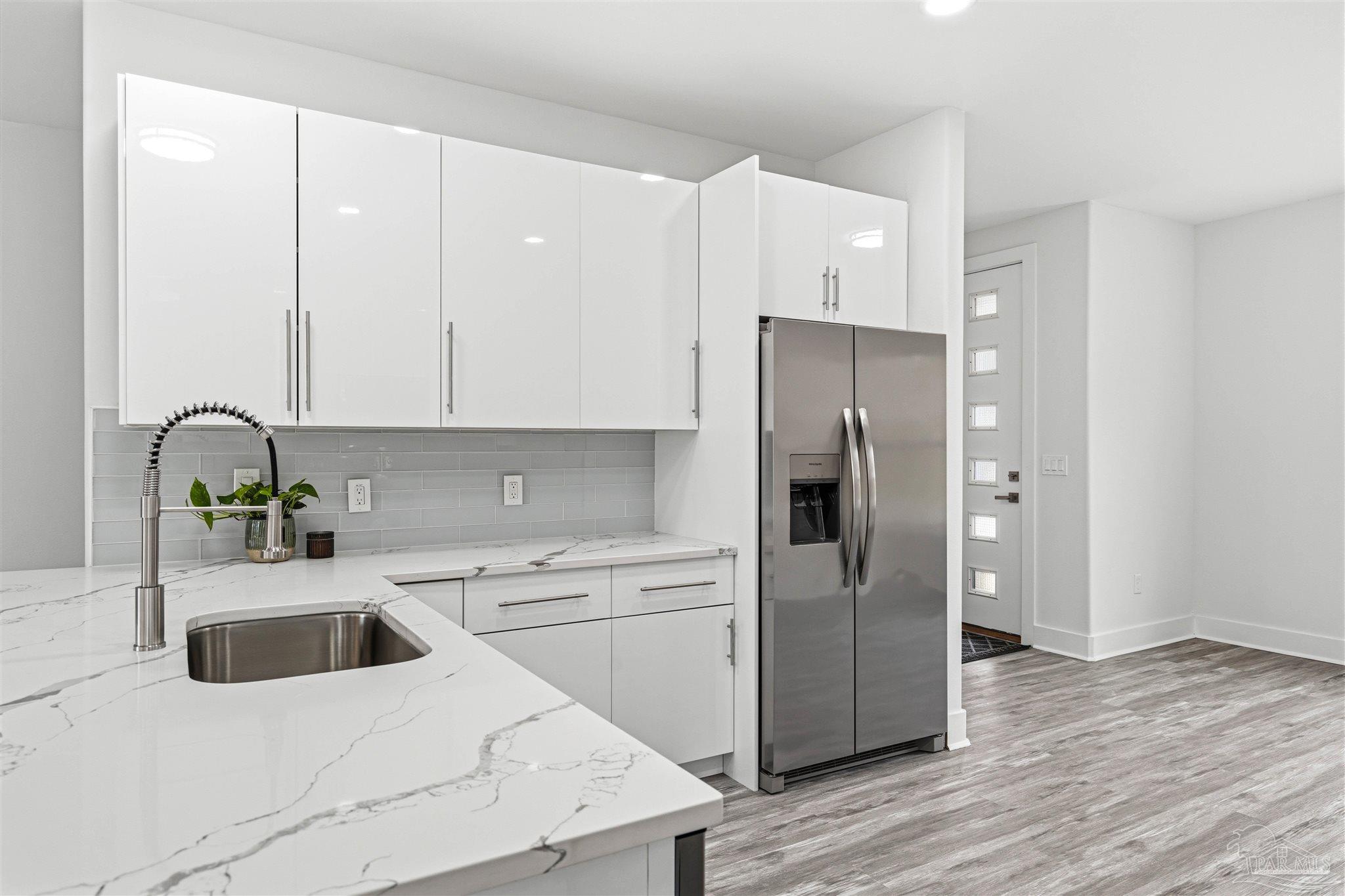 4446 Antioch Road Crestview, FL 32536 - Photo 12 of 43 a kitchen with a refrigerator sink and cabinets