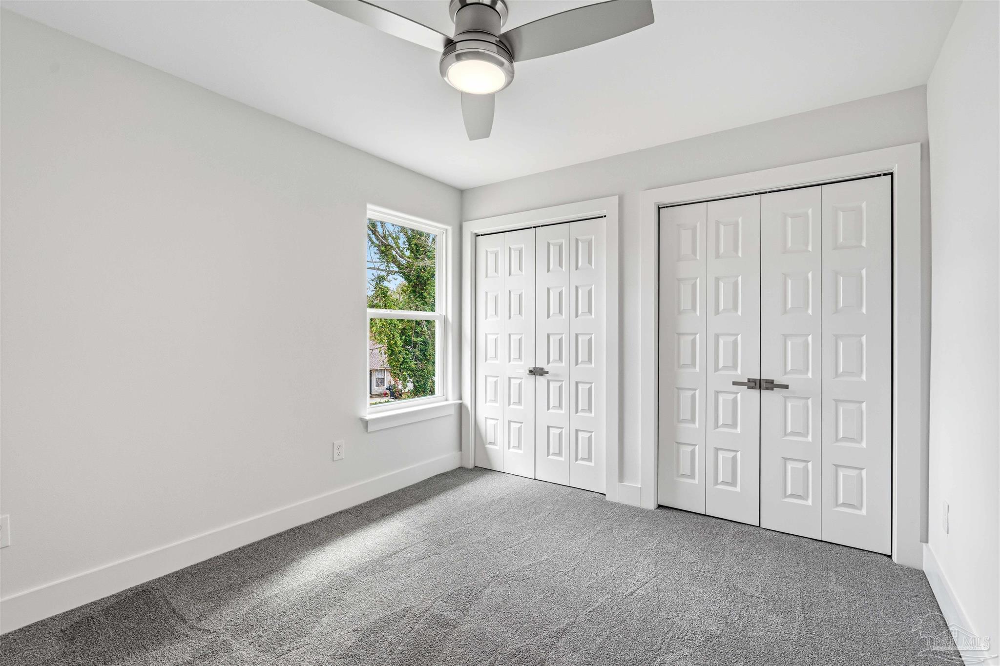 4446 Antioch Road Crestview, FL 32536 - Photo 23 of 43 an empty room with windows and ceiling fan