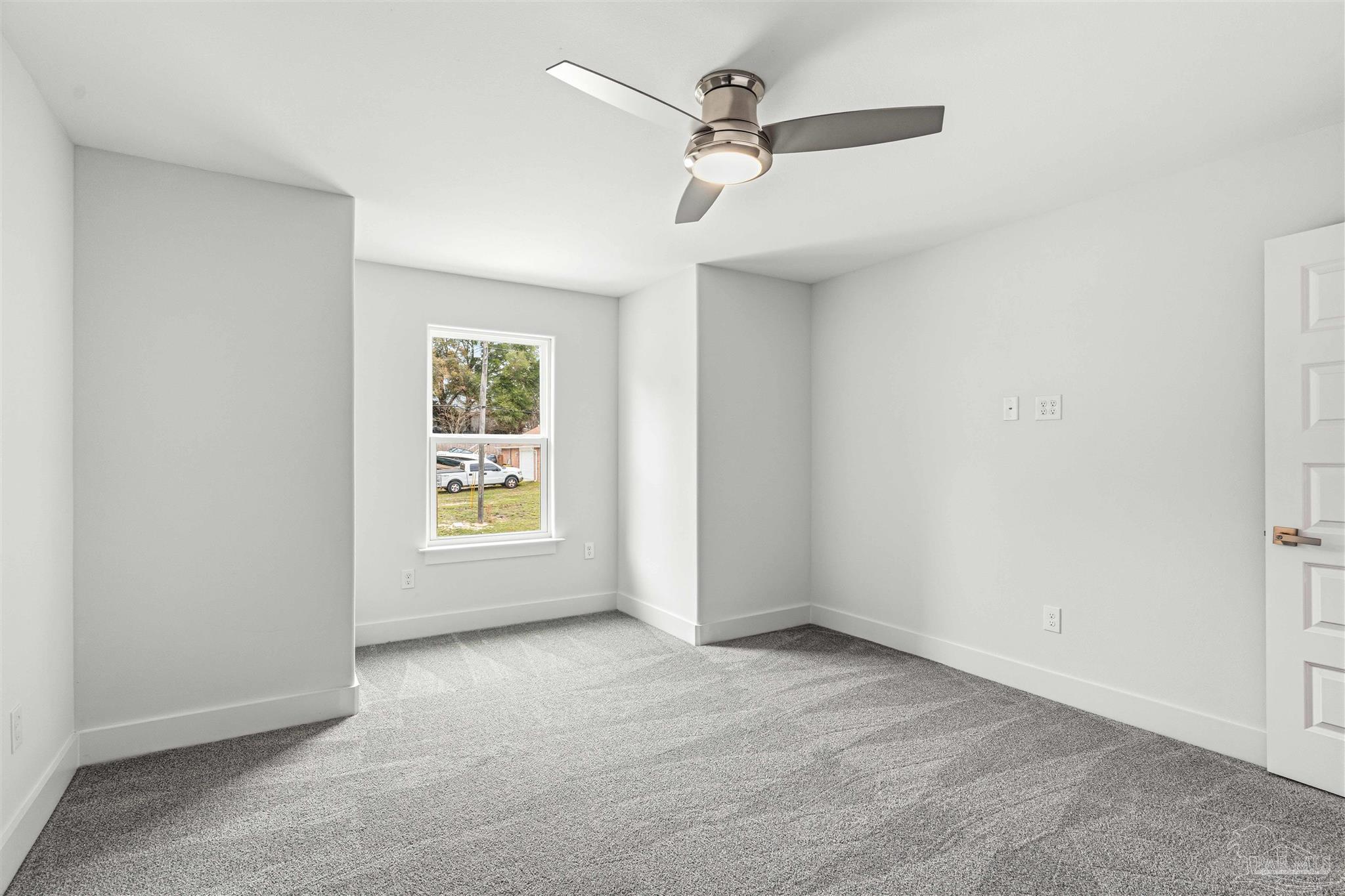 4446 Antioch Road Crestview, FL 32536 - Photo 32 of 43 an empty room with a window and a fan