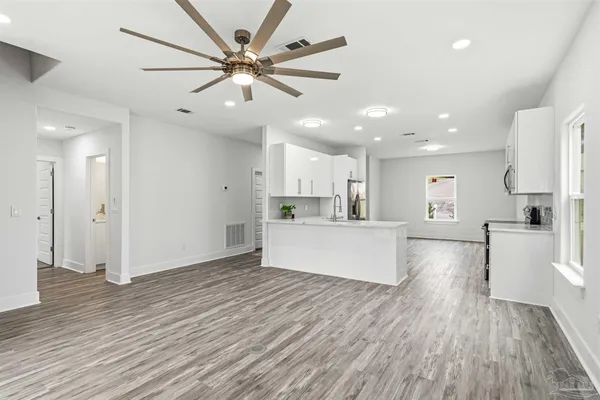 a view of kitchen with cabinets and wooden floor