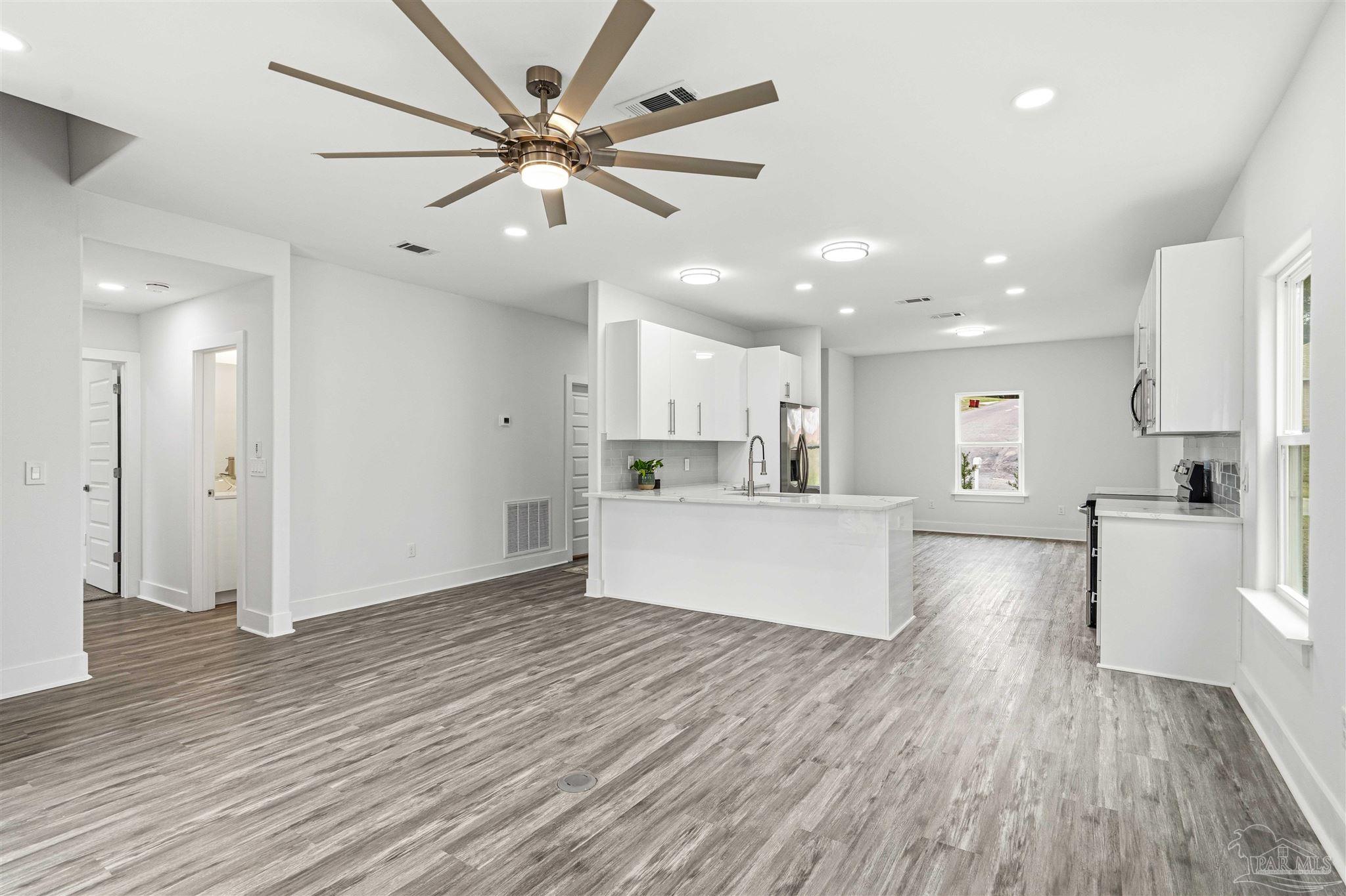 4446 Antioch Road Crestview, FL 32536 - Photo 8 of 43 a view of kitchen with cabinets and wooden floor