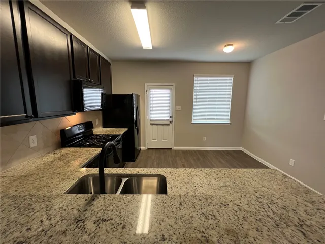 a kitchen with a sink stove and refrigerator