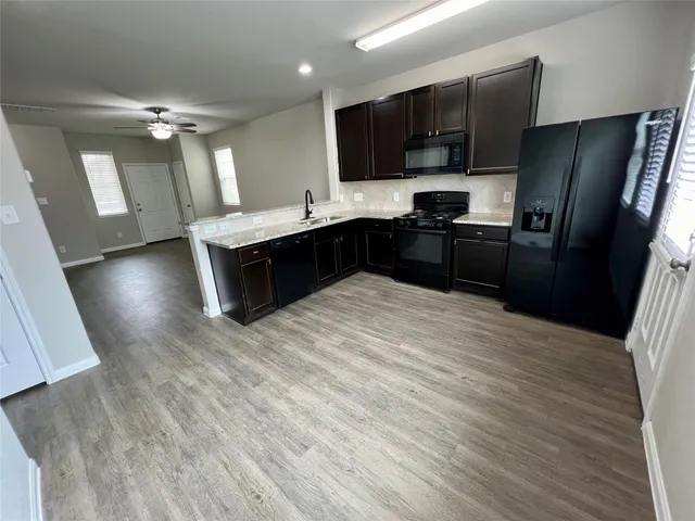 a kitchen with a refrigerator sink and microwave