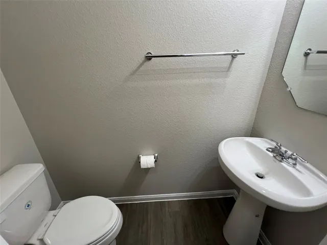 a bathroom with a sink a mirror and a toilet