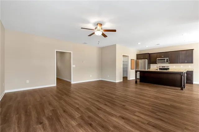 a view of kitchen with kitchen island microwave and stove
