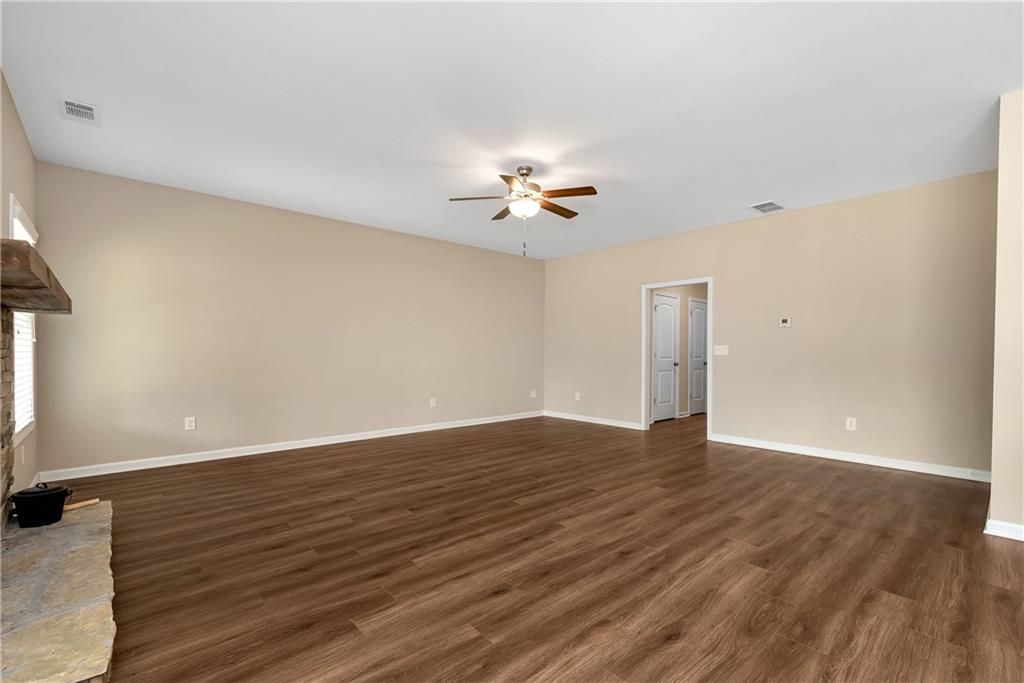 489 Asbury Mill Road Cleveland, GA 30528 - Photo 12 of 34 a view of a room with wooden floor and a ceiling fan