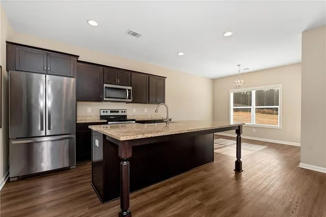 a kitchen with a stove a sink and a microwave