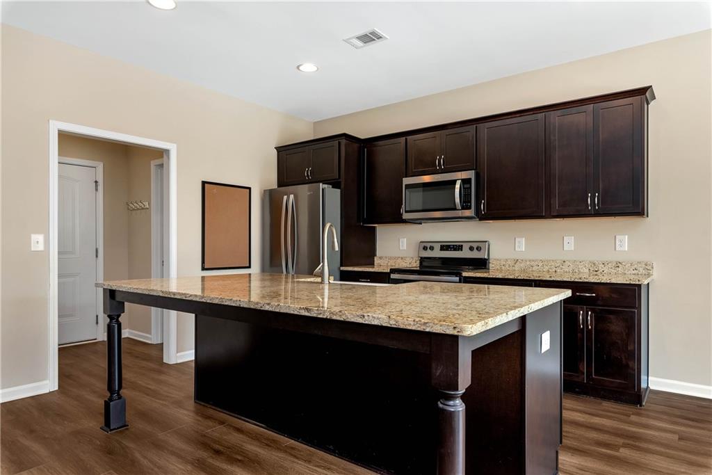 489 Asbury Mill Road Cleveland, GA 30528 - Photo 15 of 34 a kitchen with a stove a sink and a microwave