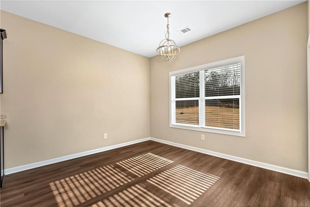 489 Asbury Mill Road Cleveland, GA 30528 - Photo 16 of 34 a view of an empty room with wooden floor and a window