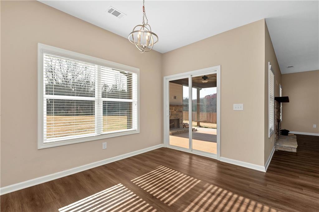 489 Asbury Mill Road Cleveland, GA 30528 - Photo 18 of 34 a view of an empty room with wooden floor and a window