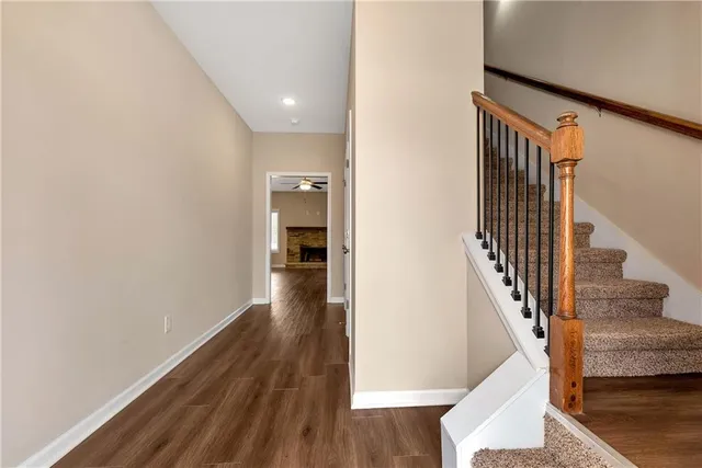 a view of entryway and hall with wooden floor