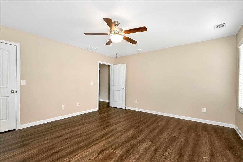 489 Asbury Mill Road Cleveland, GA 30528 - Photo 34 of 34 an empty room with wooden floor and windows