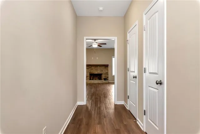 a view of a hallway with wooden floor and staircase