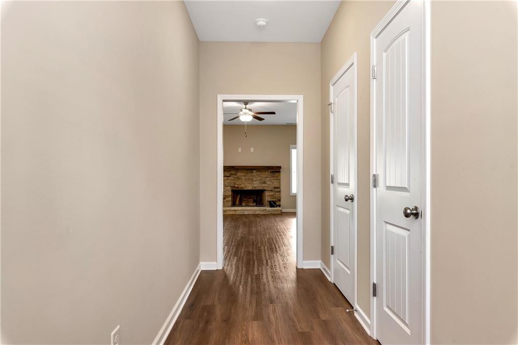 489 Asbury Mill Road Cleveland, GA 30528 - Photo 6 of 34 a view of a hallway with wooden floor and staircase