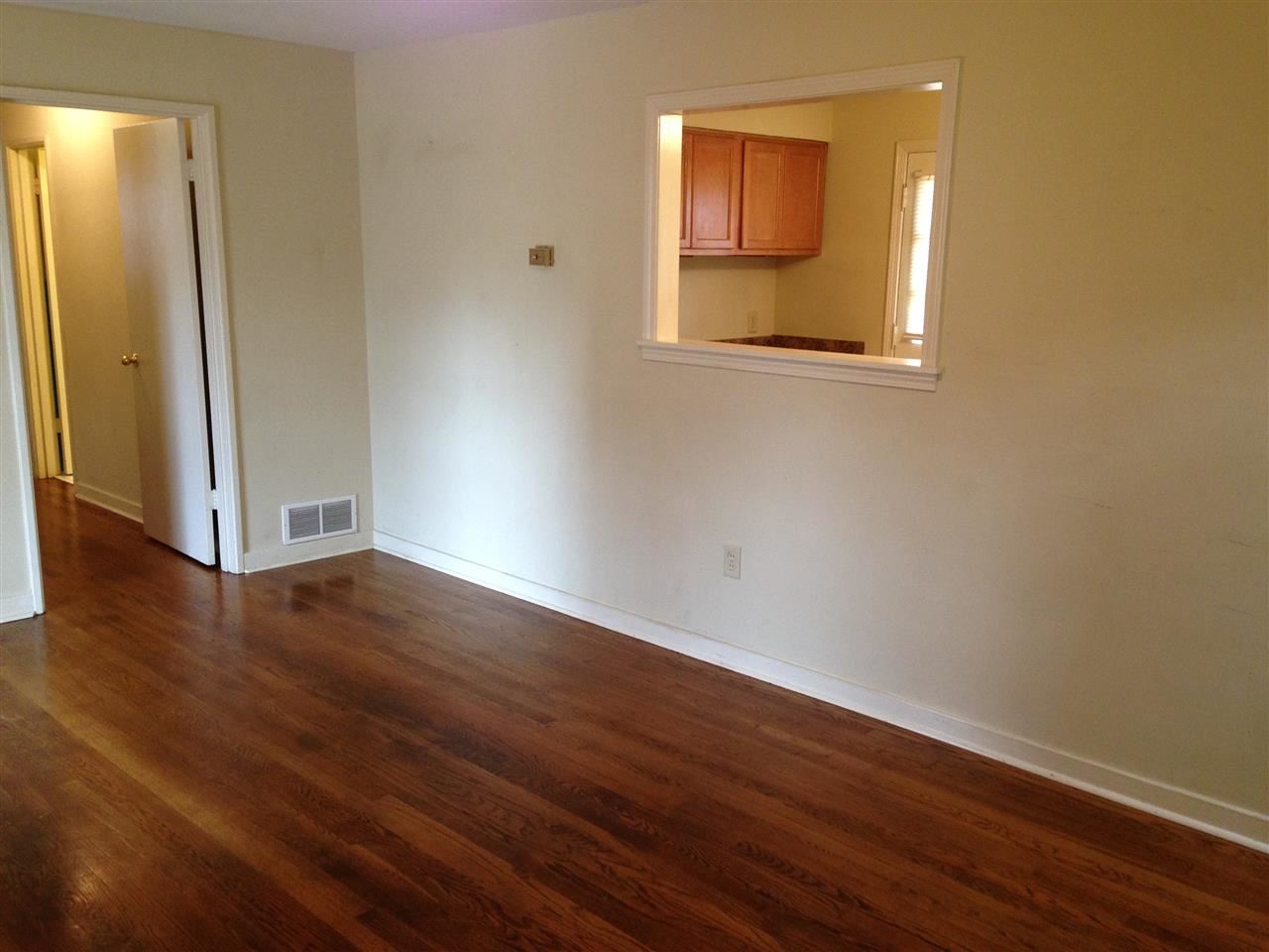 376 Malboro Road Memphis, TN 38120 - Photo 2 of 5 an empty room with wooden floor and a window