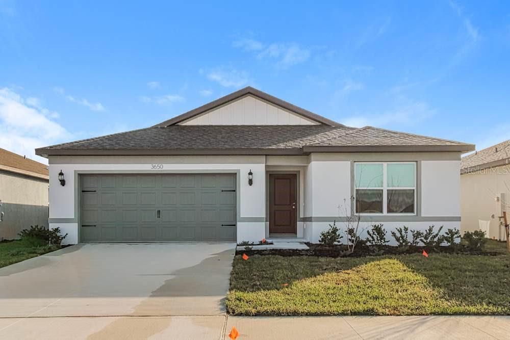 3650 Benham Rise Road Spring Hill, FL 34609 - Photo 1 of 7 a front view of a house with garden
