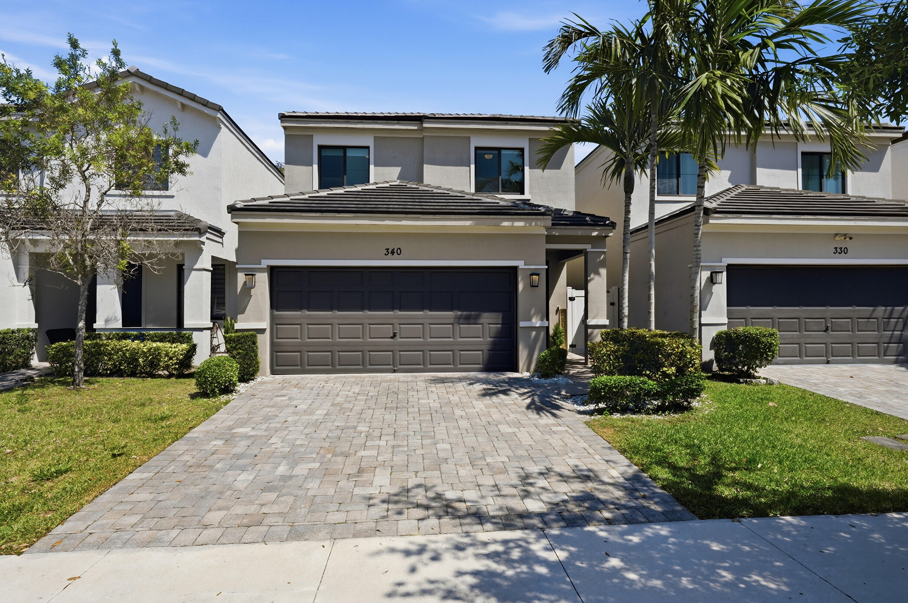 340 Northwest 33rd Lane Pompano Beach, FL 33069 - Photo 1 of 47 a front view of a house with a yard and garage
