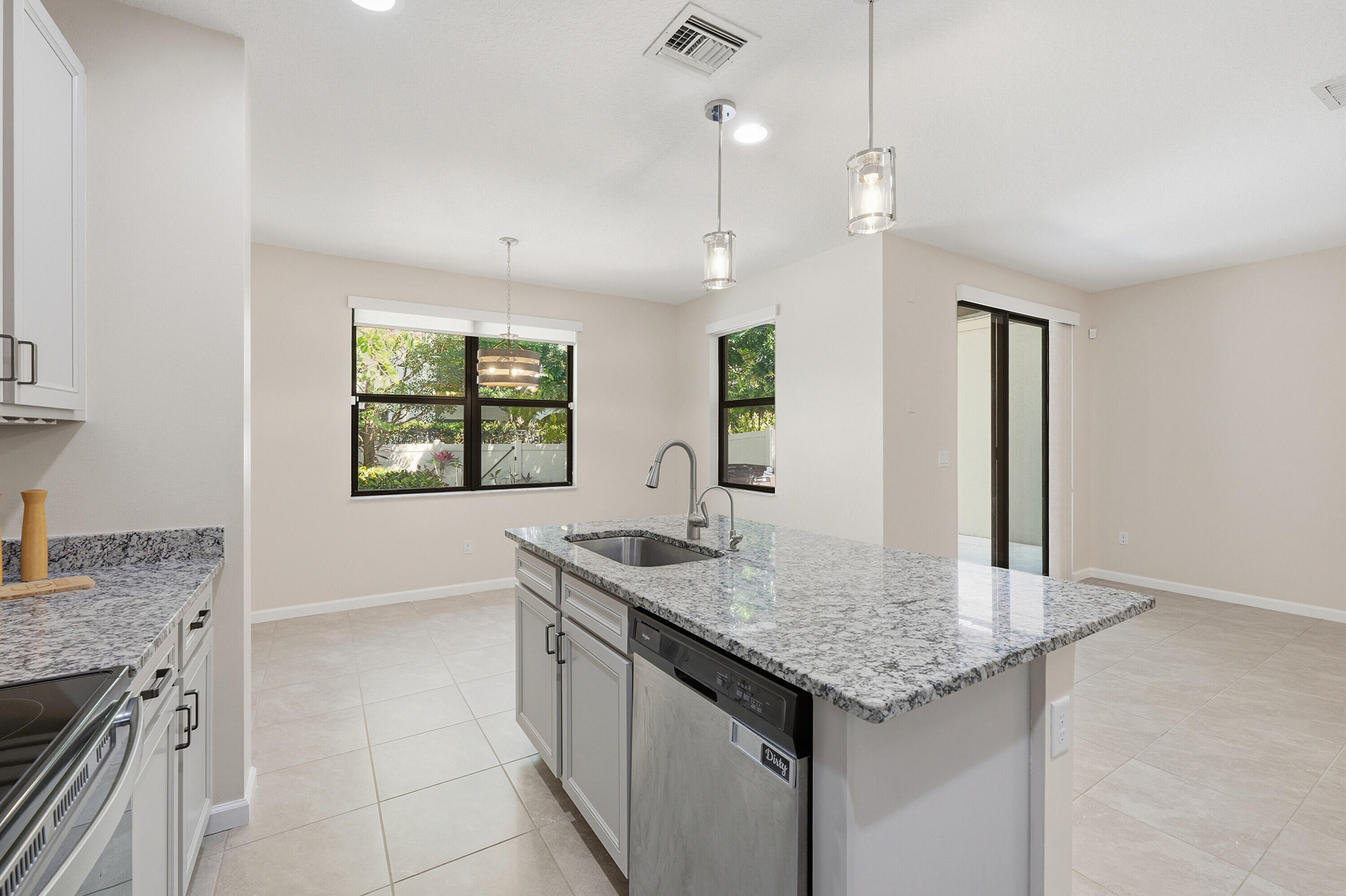 340 Northwest 33rd Lane Pompano Beach, FL 33069 - Photo 12 of 47 a kitchen with granite countertop kitchen island a sink appliances and a counter space