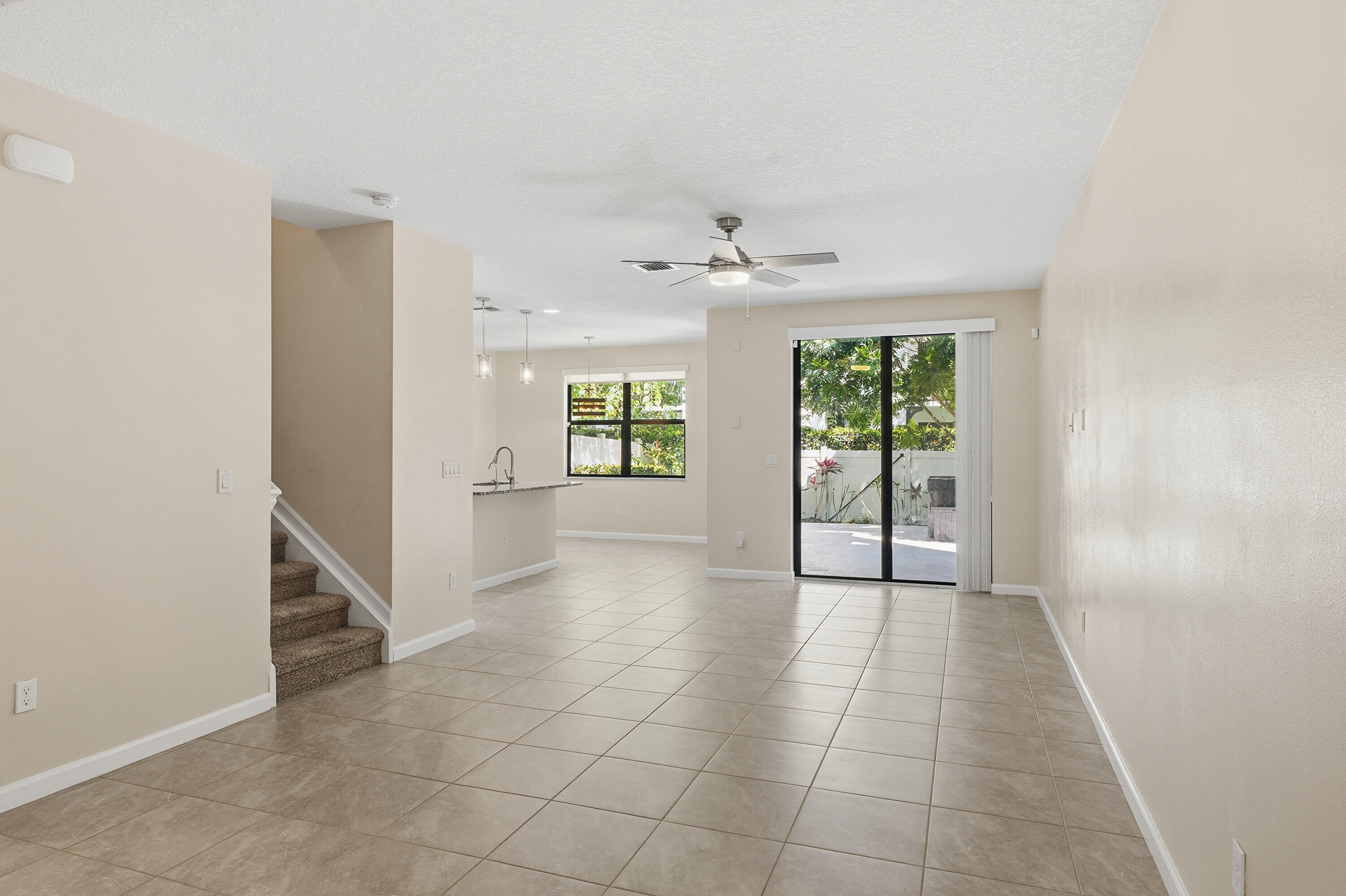 340 Northwest 33rd Lane Pompano Beach, FL 33069 - Photo 2 of 47 an empty room with windows and chandelier