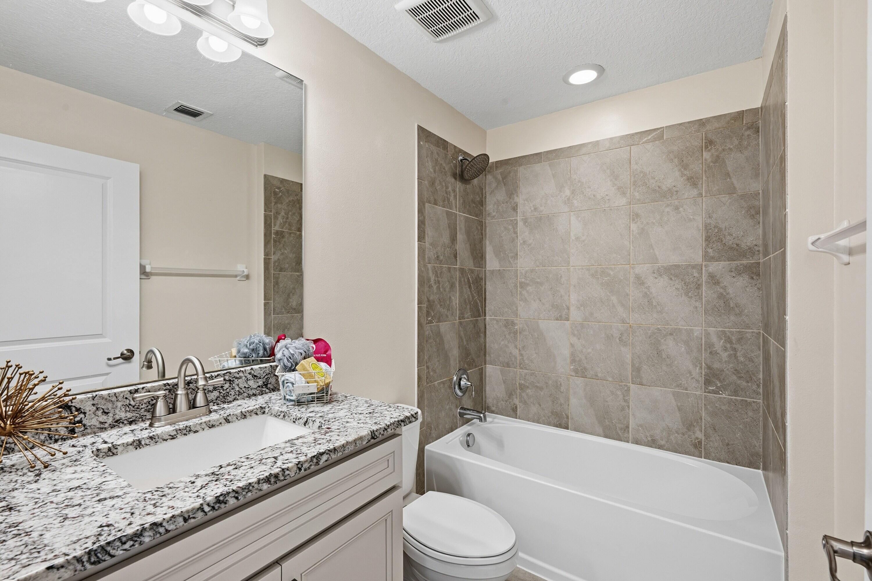 340 Northwest 33rd Lane Pompano Beach, FL 33069 - Photo 31 of 47 a bathroom with a granite countertop sink mirror toilet and bathtub