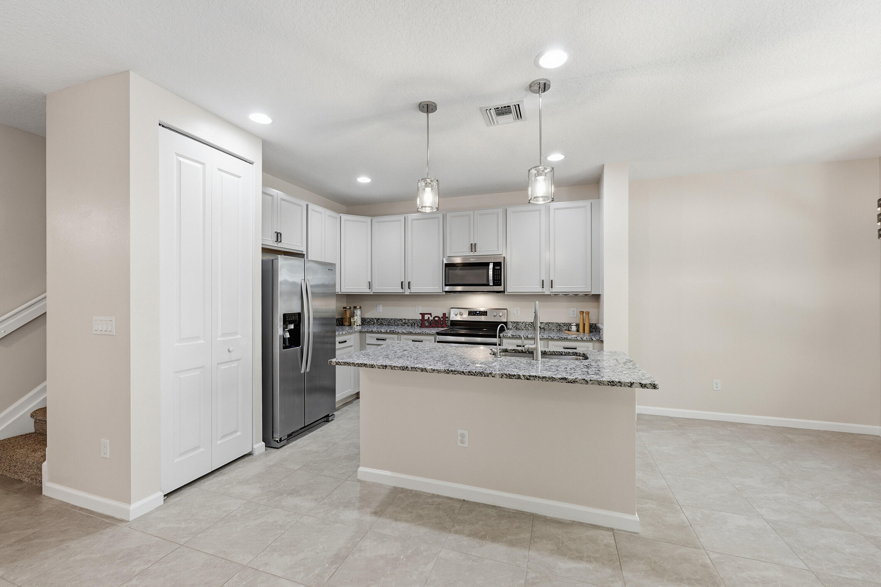 340 Northwest 33rd Lane Pompano Beach, FL 33069 - Photo 9 of 47 a kitchen with stainless steel appliances a refrigerator sink and microwave