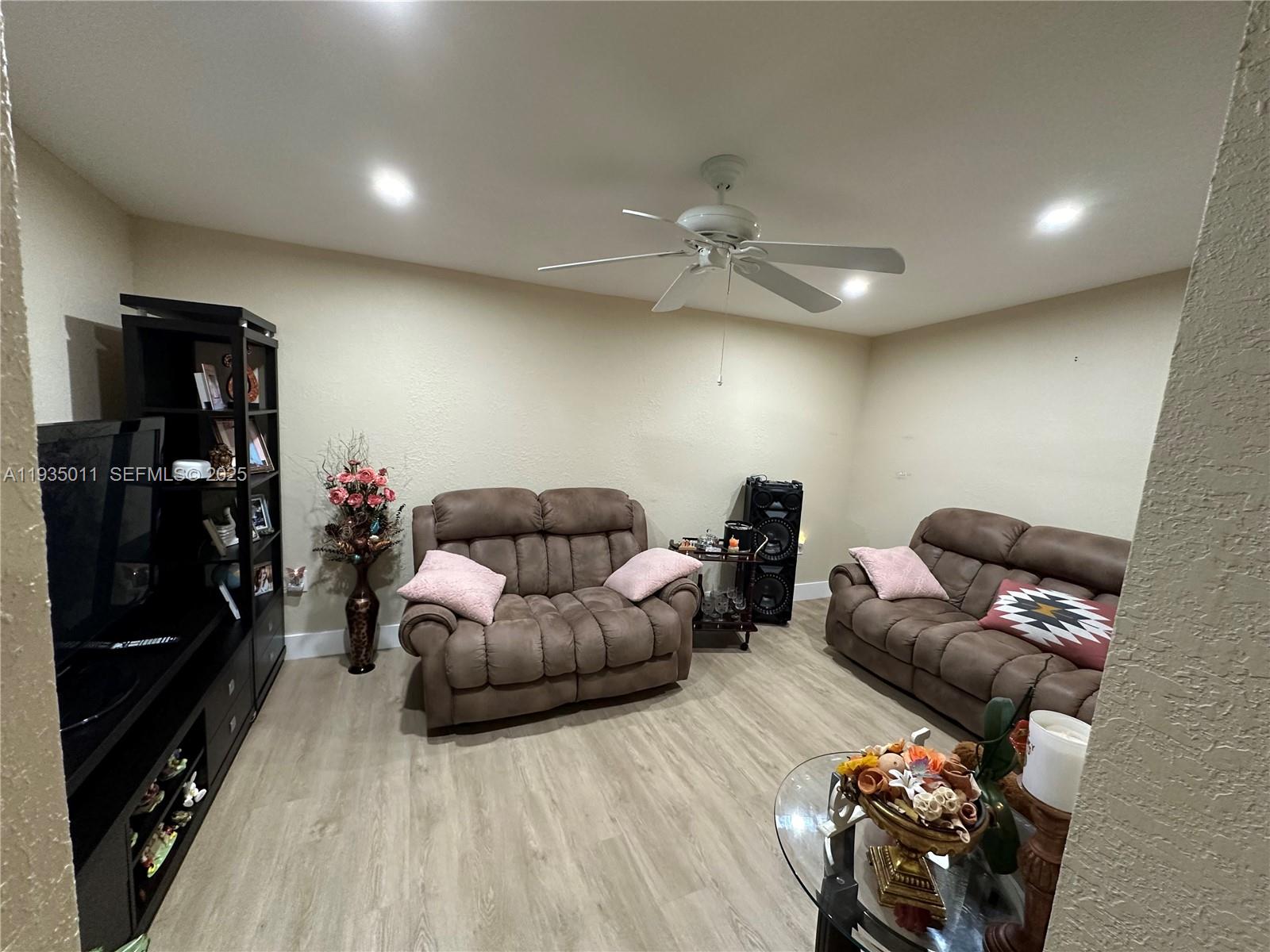 19360 Southwest 116th Avenue Miami, FL 33157 - Photo 5 of 17 a living room with furniture and a flat screen tv