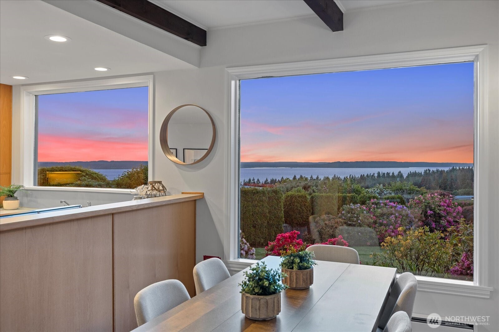 18220 Ridgefield Road Northwest Shoreline, WA 98177 - Photo 18 of 40 a view of a house with a potted plant and a floor to ceiling window