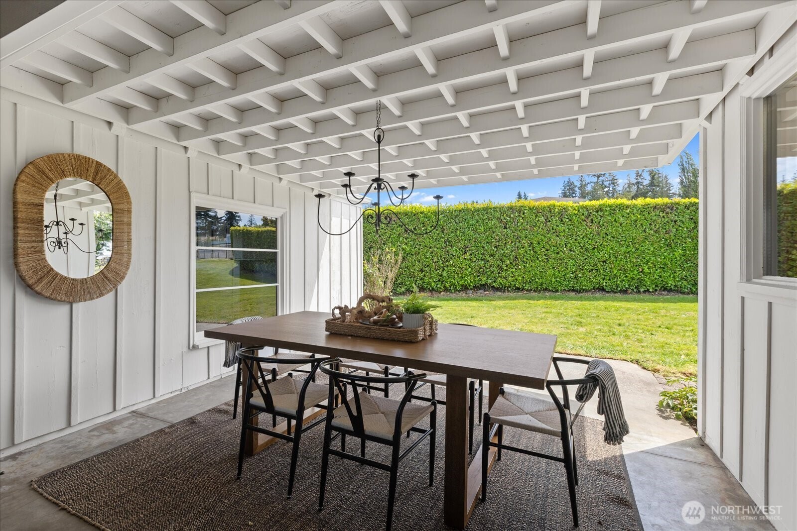 18220 Ridgefield Road Northwest Shoreline, WA 98177 - Photo 20 of 40 a view of a dining table and chairs in a patio