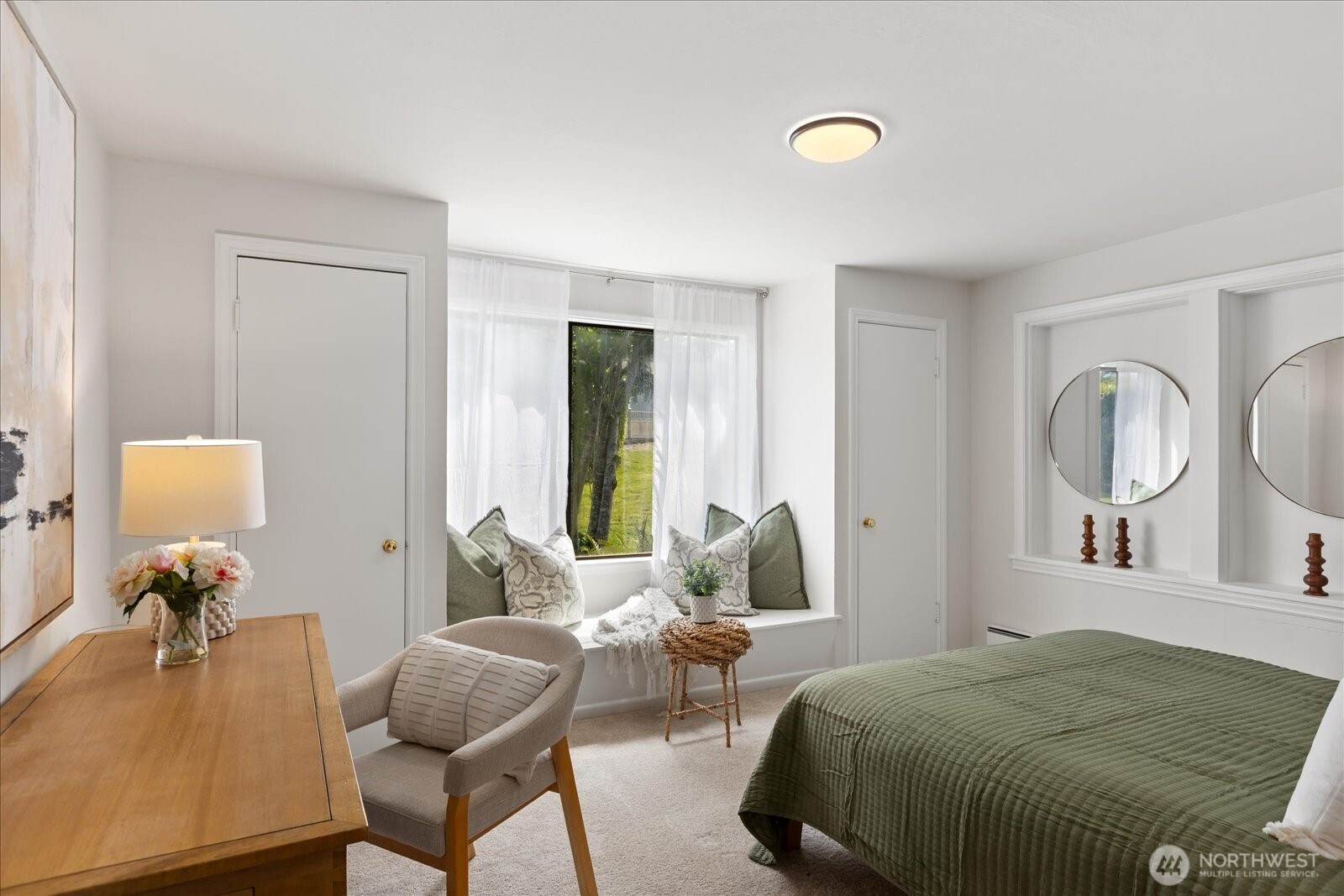 18220 Ridgefield Road Northwest Shoreline, WA 98177 - Photo 22 of 40 a bedroom with a bed and a chandelier