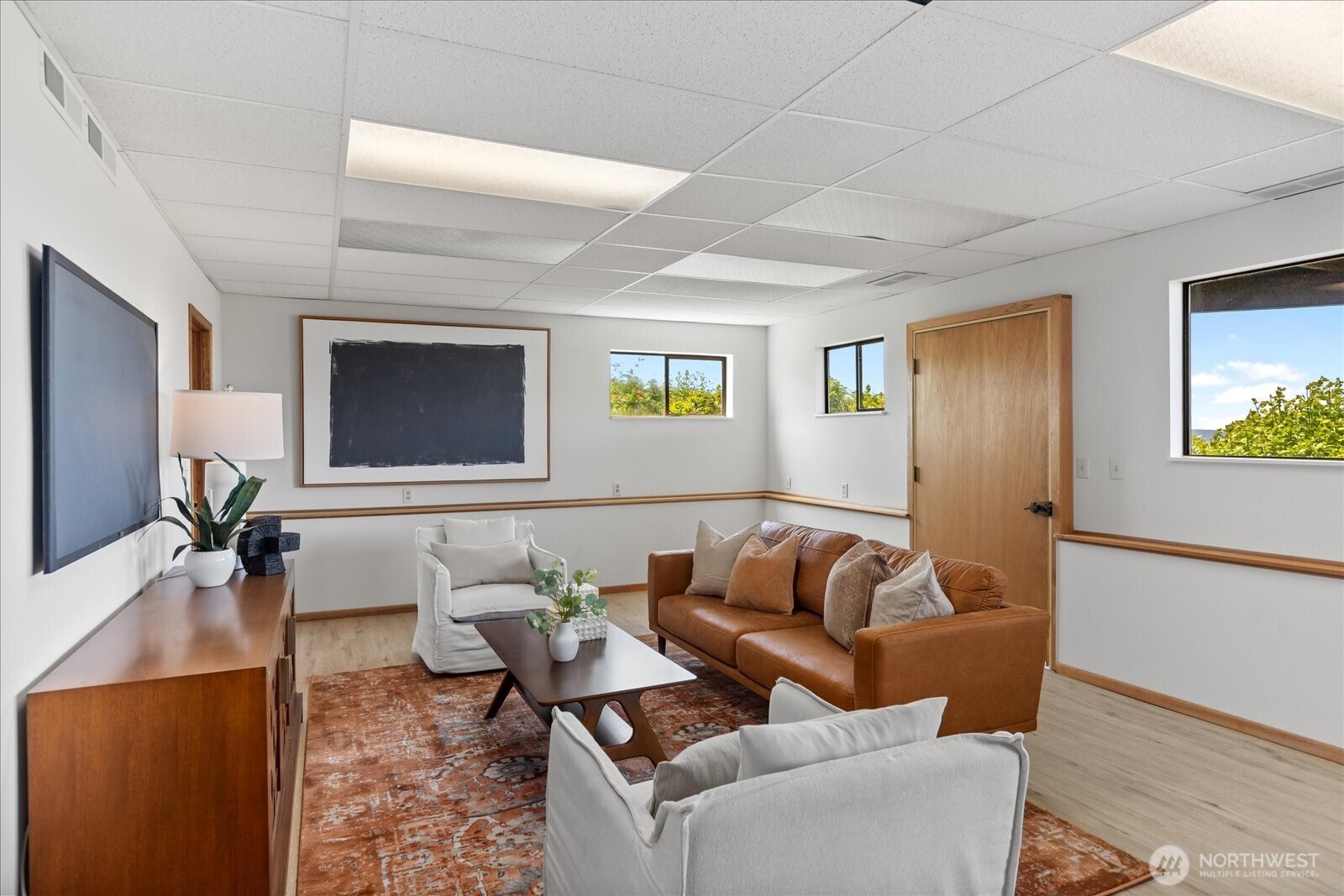 18220 Ridgefield Road Northwest Shoreline, WA 98177 - Photo 30 of 40 a living room with furniture and a flat screen tv