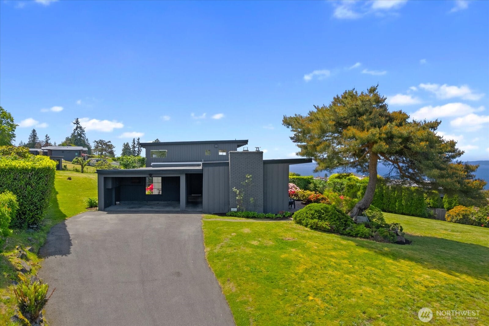18220 Ridgefield Road Northwest Shoreline, WA 98177 - Photo 6 of 40 a front view of a house with a yard and garage