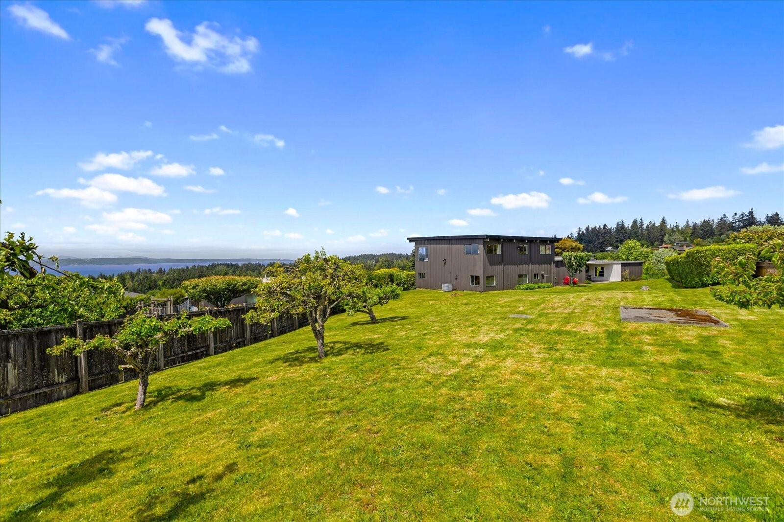 18220 Ridgefield Road Northwest Shoreline, WA 98177 - Photo 7 of 40 a view of a lake with a big yard