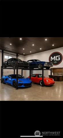 a front view of a house with cars parked