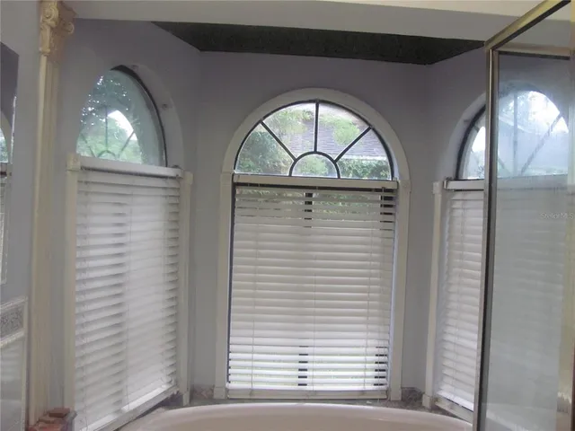 a view of an empty room with a kitchen