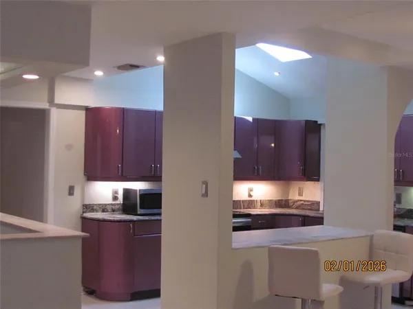 a view of a living room and floor to ceiling window or kitchen
