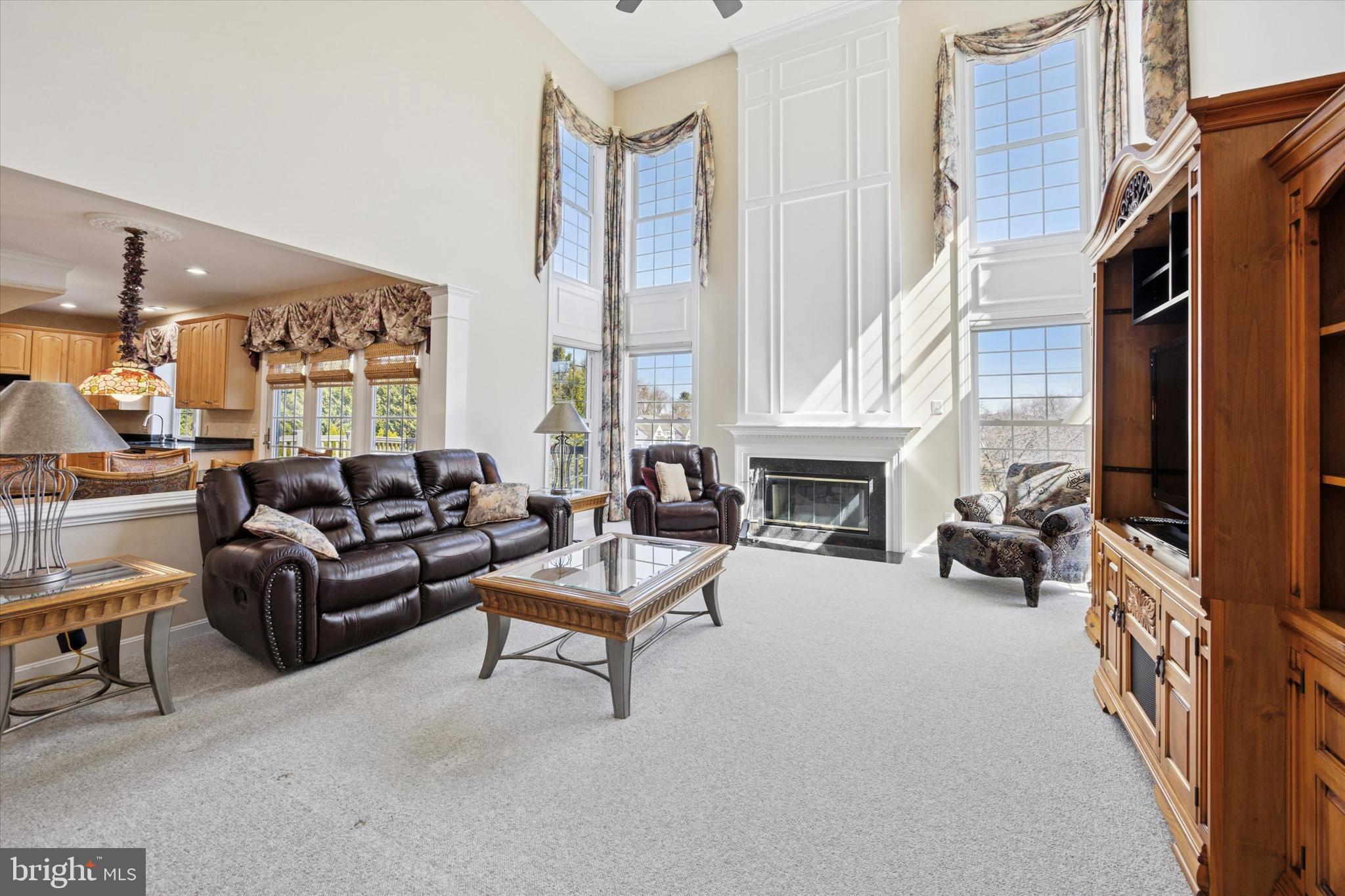 128 Applegate Drive West Chester, PA 19382 - Photo 13 of 36 a living room with furniture a fireplace and a large window