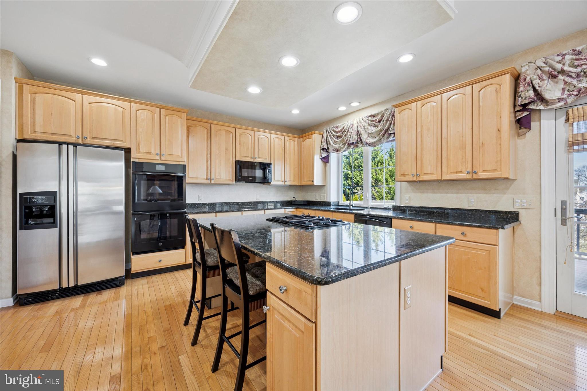 128 Applegate Drive West Chester, PA 19382 - Photo 16 of 36 a kitchen with stainless steel appliances granite countertop a refrigerator a sink dishwasher a stove and white cabinets with wooden floor