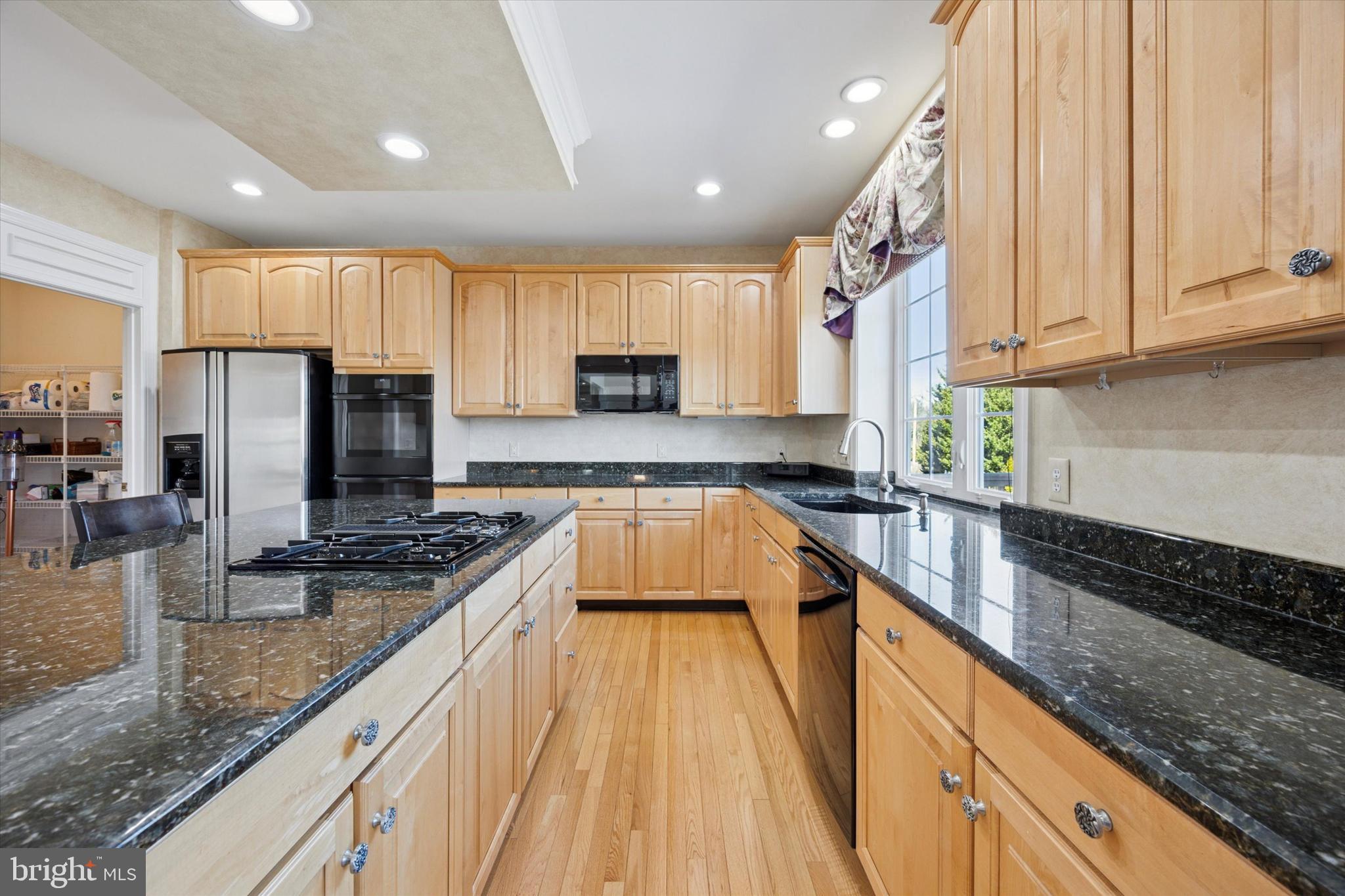 128 Applegate Drive West Chester, PA 19382 - Photo 17 of 36 a kitchen with stainless steel appliances granite countertop a sink a stove and a refrigerator